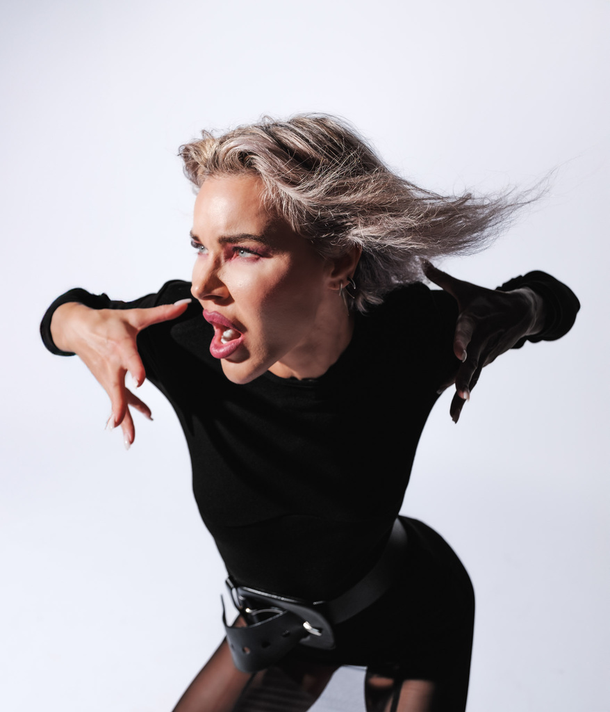 Exaggerated pointing gesture, hair mid-motion
