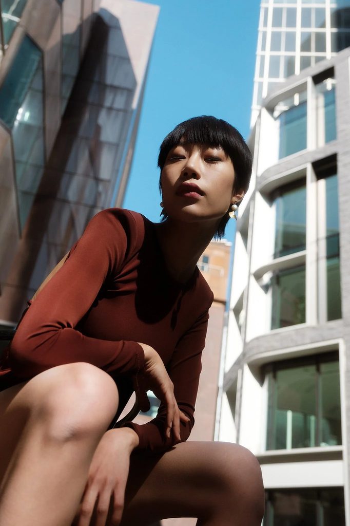 Seated pose outdoors, relaxed and candid